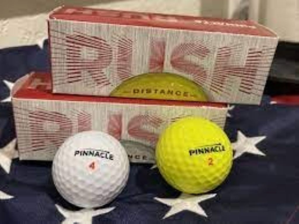 Beginner player smiling after straight drive using Pinnacle Soft golf ball on course.